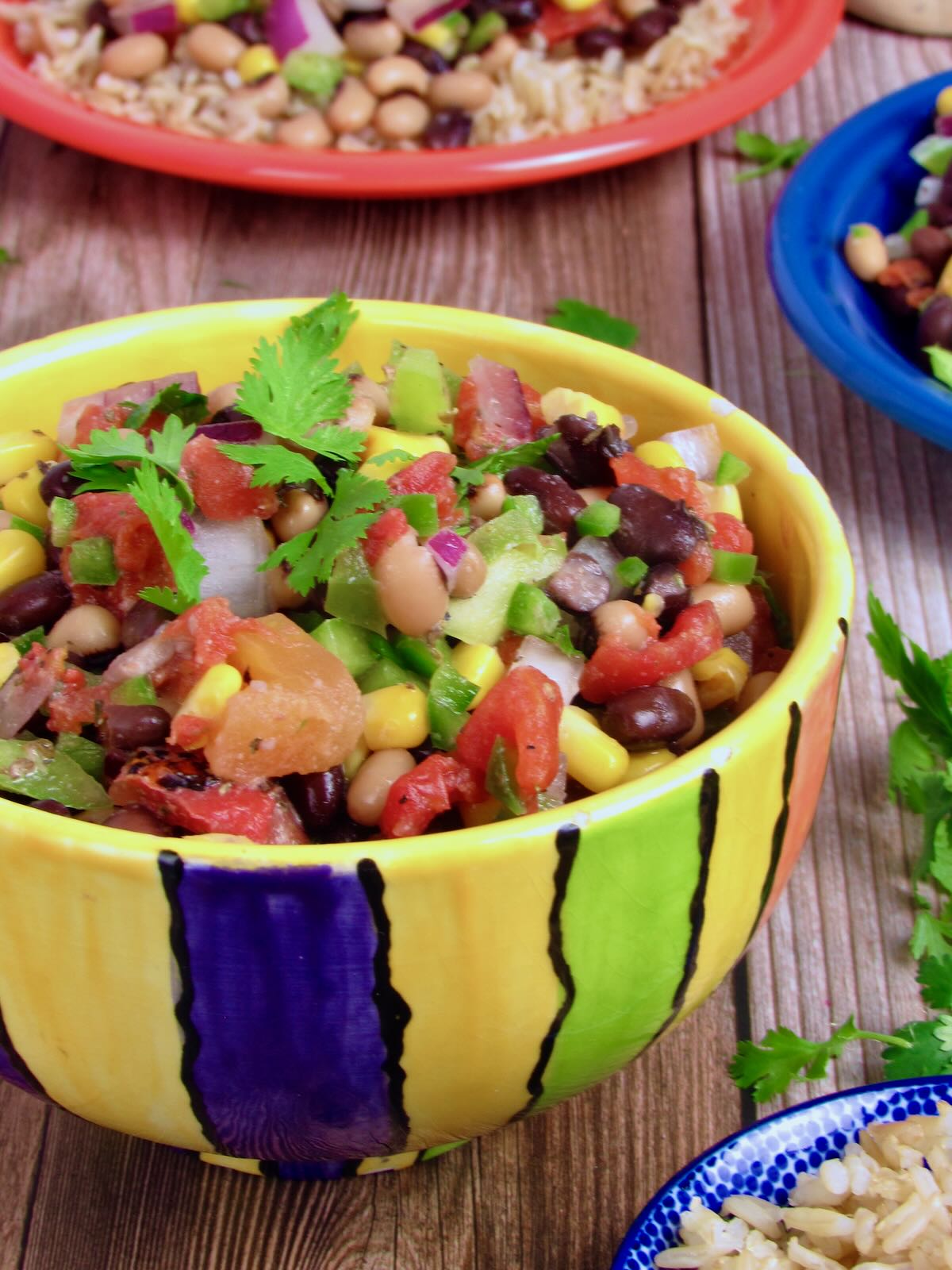 Cowboy Caviar, served as a dip in a brightly colored serving bowl.