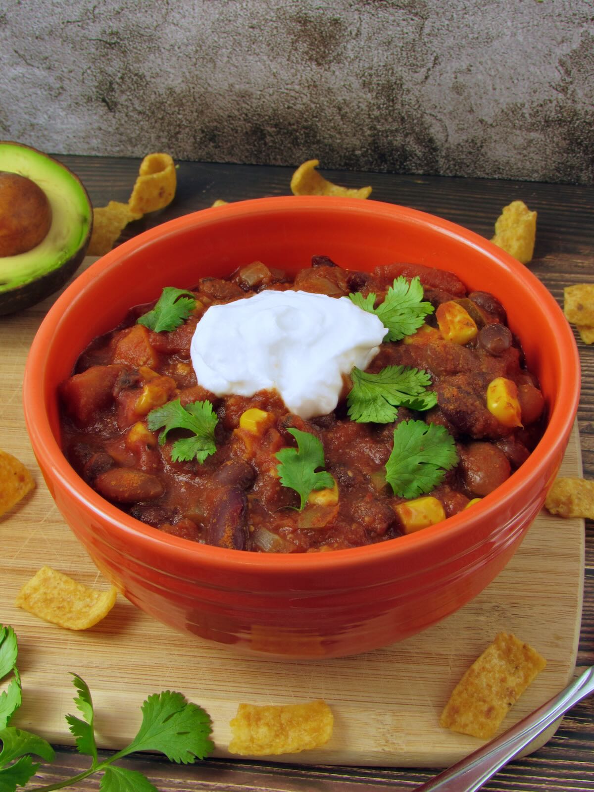 Easy Instant Pot Chili recipe, topped with cilantro and coconut yogurt and served on fritos as frito chili pie.
