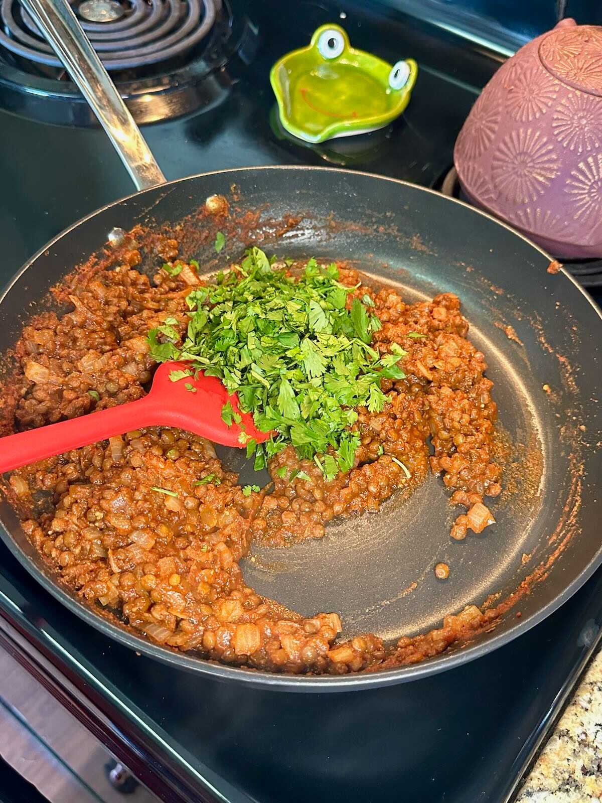 Adding cilantro to Vegan Taco Meat.