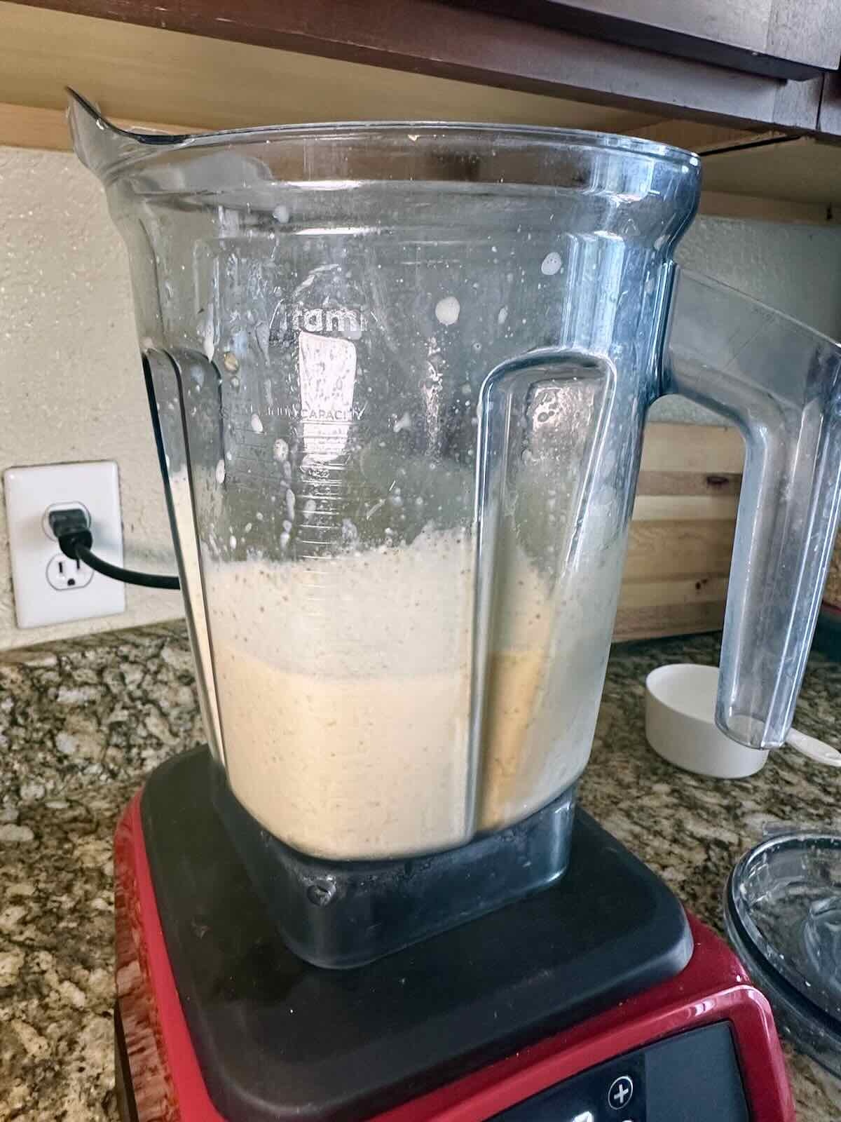 Blended creamy dairy-free apple smoothie in a blender.