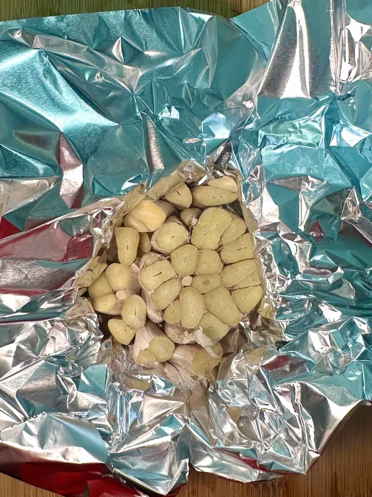 Garlic wrapped in foil to be roasted for Vegan Baba Ganoush.