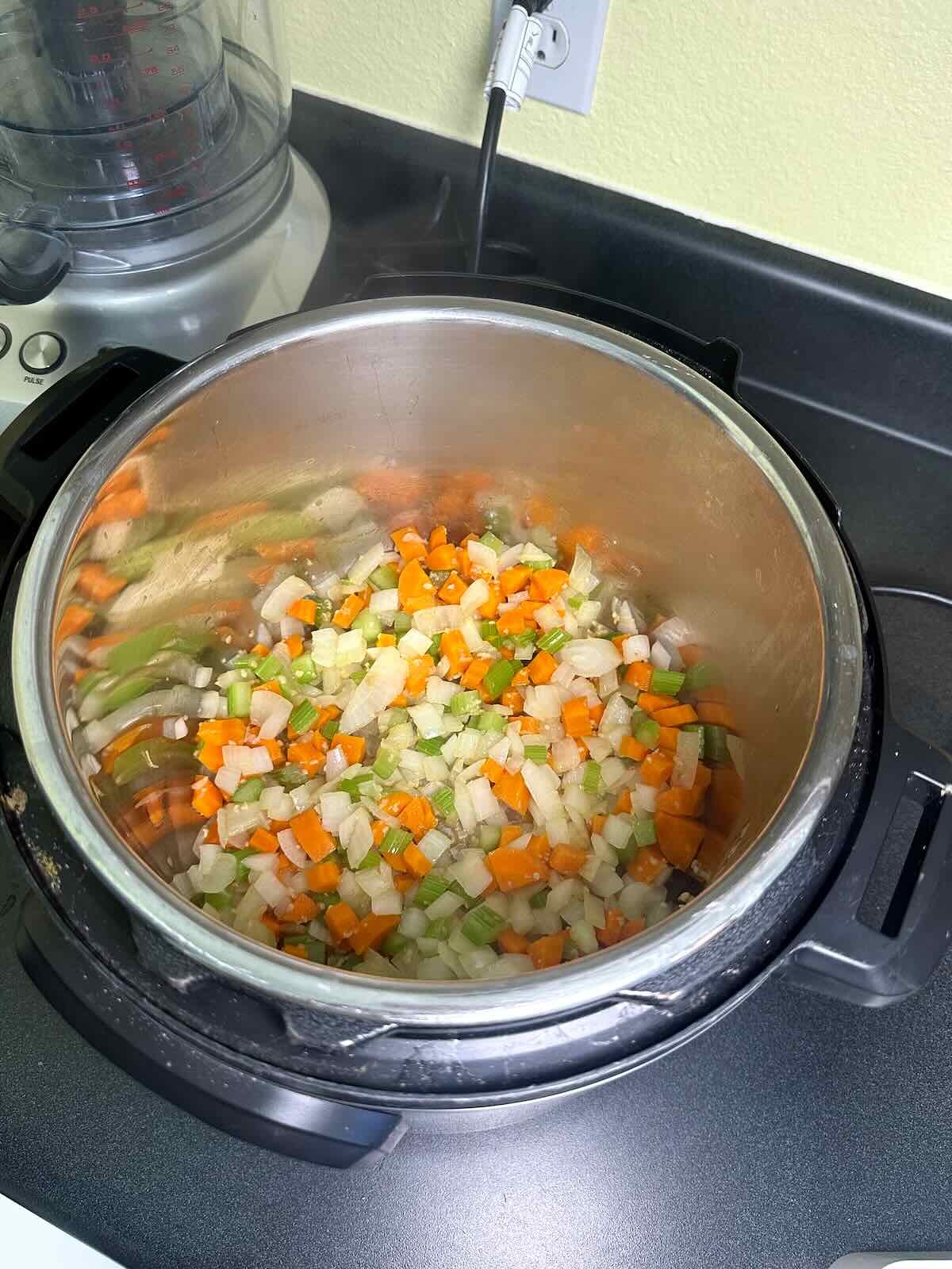 Sautéing veggies in the Instant Pot for Tuscan White Bean Soup. 