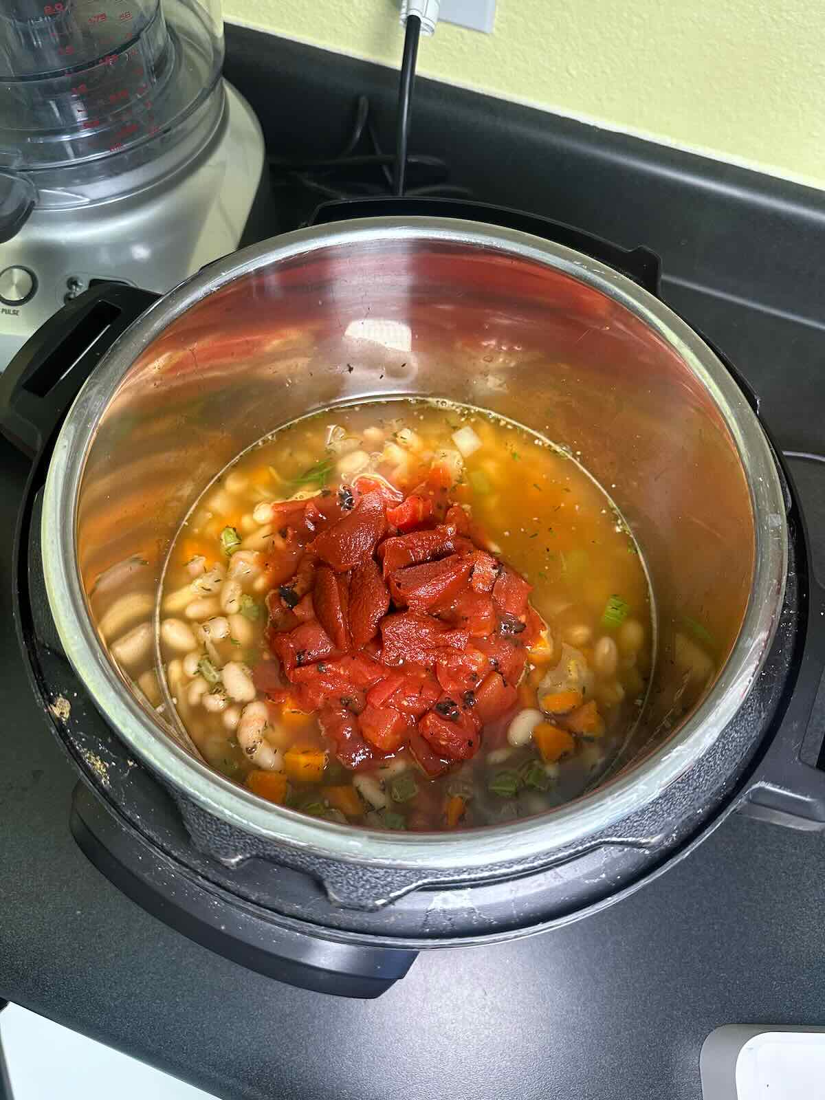 Fire roasted tomatoes and tomato paste added to vegan Instant Pot soup. 