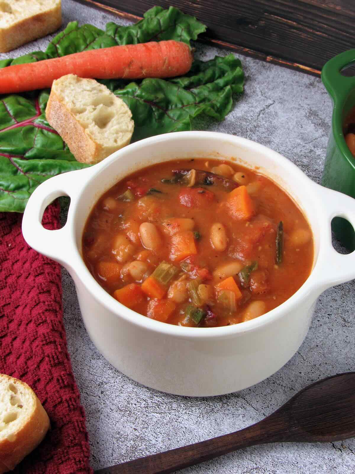 Tuscan-inspired White Bean Soup with crusty baguette and fresh veggies.