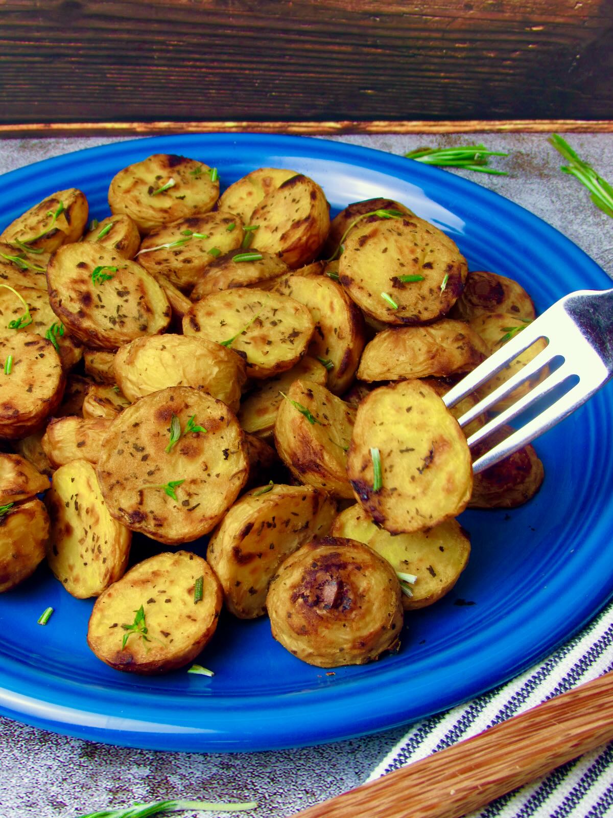 Close-up of Crispy Roasted Potatoes without oil, garnished with fresh herbs.