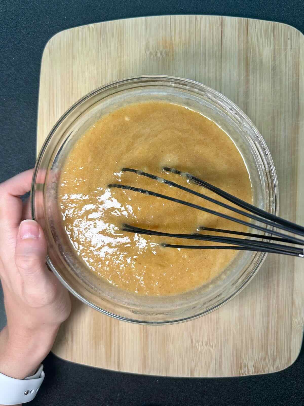 Whisking together wet ingredients for Vegan Banana Bread.