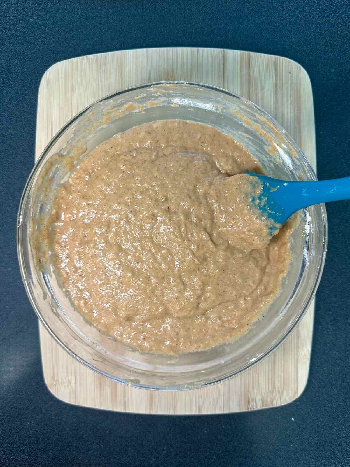 Combining wet and dry ingredients in vegan baking.