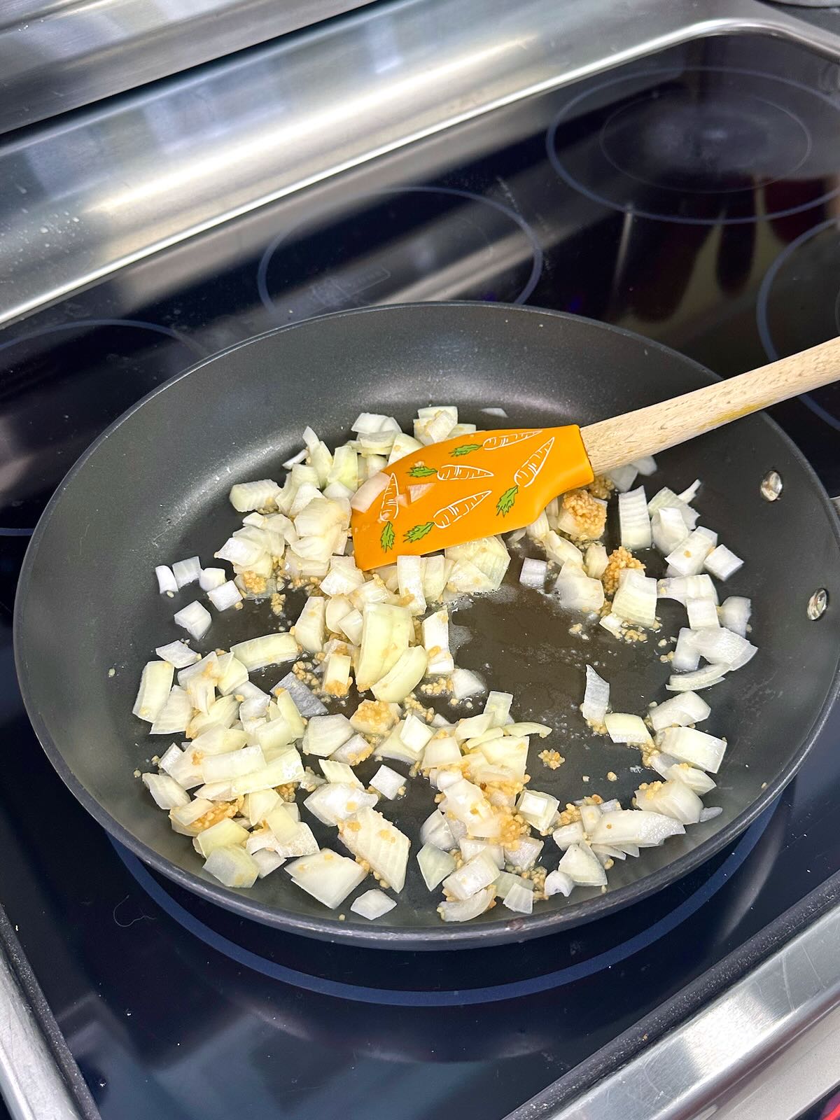Sautéing onions and garlic for Mediterranean vegan pasta.