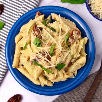 Creamy Lemon Hummus Pasta with sun-dried tomatoes and artichokes.