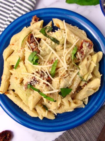 Creamy Lemon Hummus Pasta with sun-dried tomatoes and artichokes.