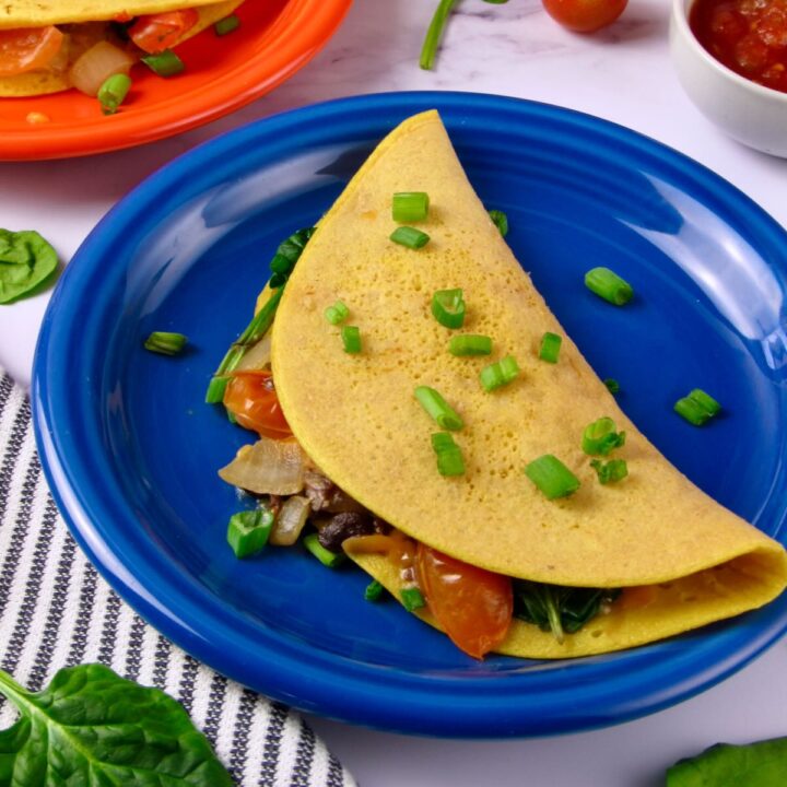 Vegan Omelet with Homemade Mung Bean Eggs, filled with sautéed veggies and vegan cheese.