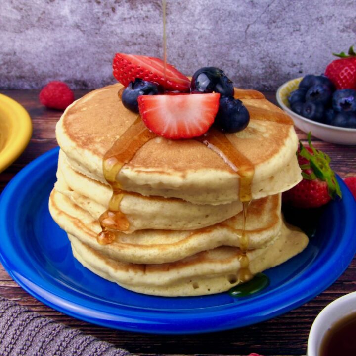 Vegan Buttermilk Pancakes, served with fresh berries and pure maple syrup.