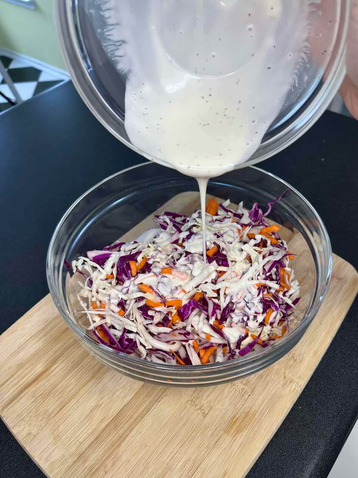 Combining tangy dressing and crunchy veggies to make summer coleslaw.