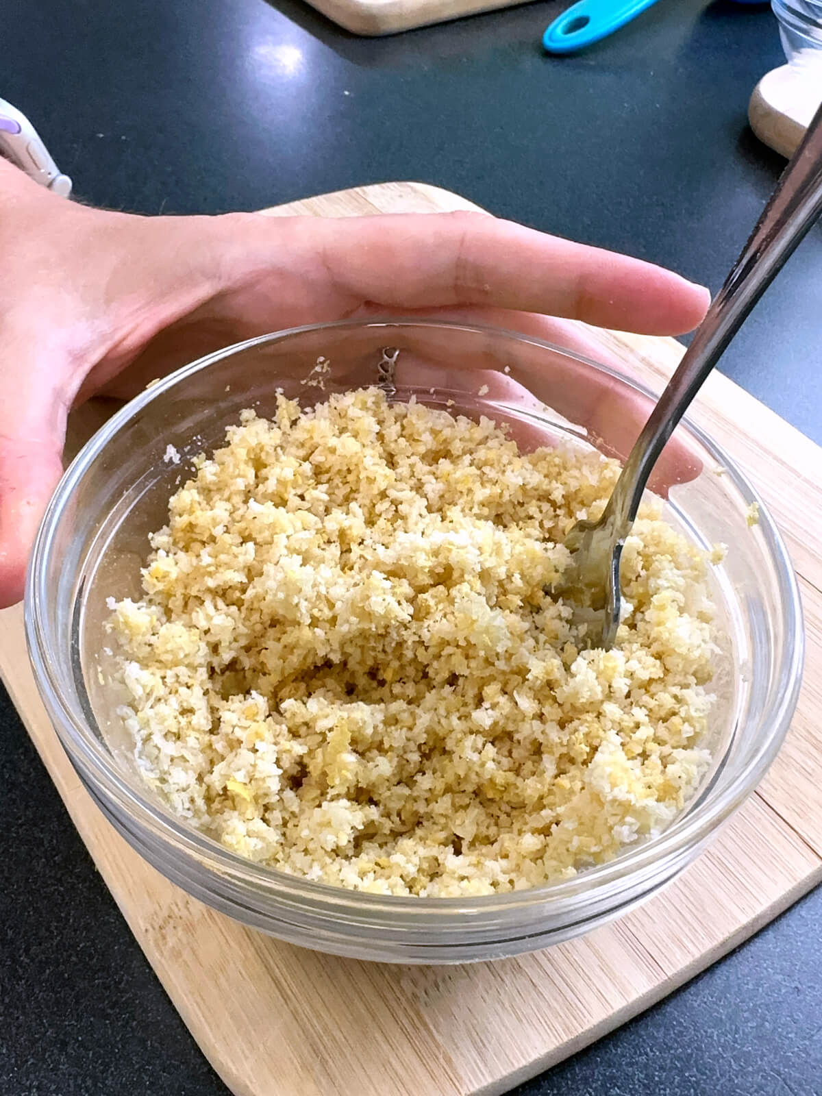 Mixing together a crispy breadcrumb mixture for topping jalapeño poppers.