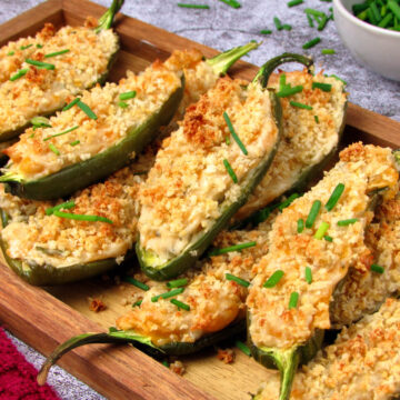 Vegan jalapeño poppers stuffed with vegan cream cheese and topped with crispy golden breadcrumbs.